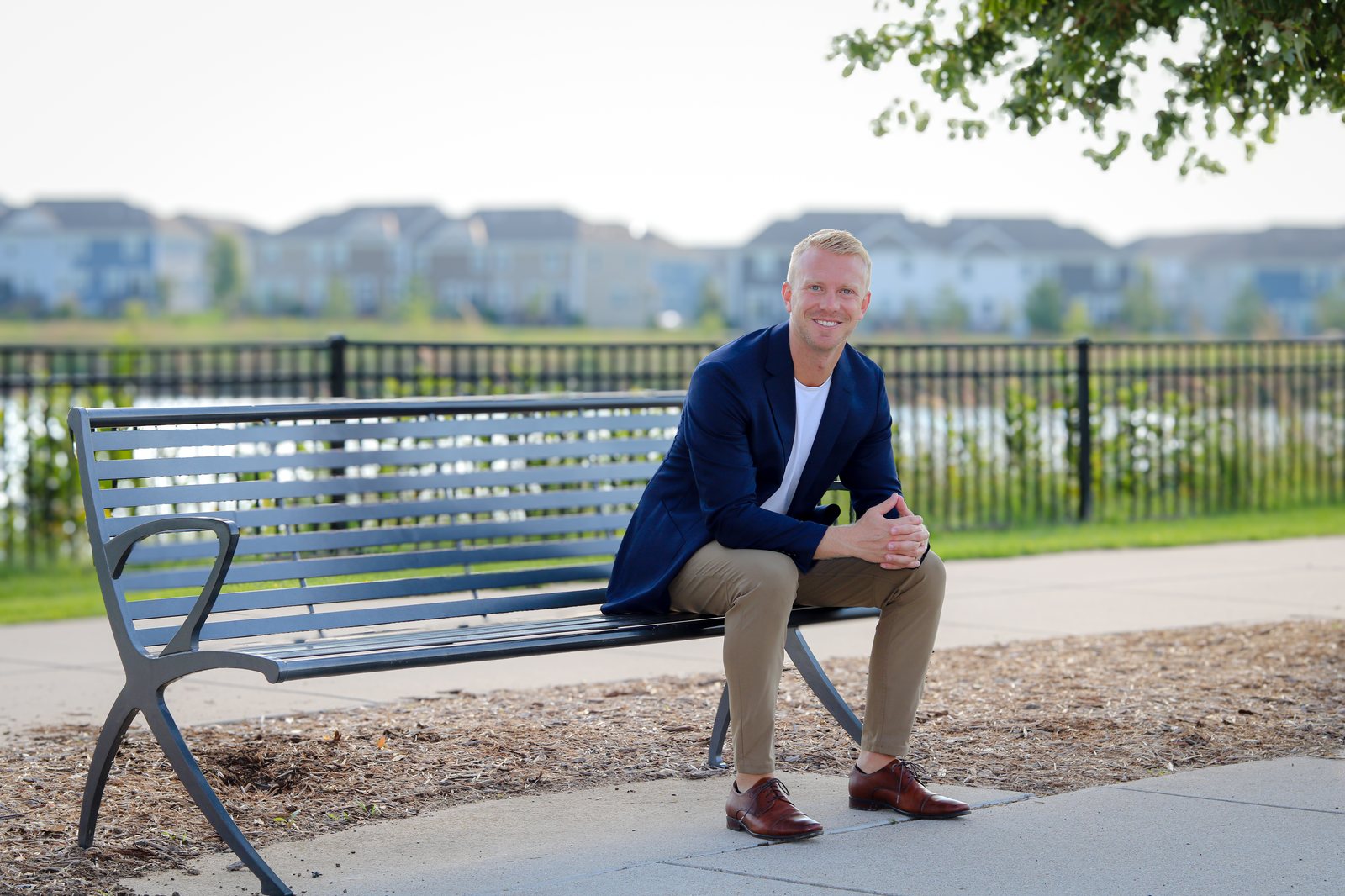 Adam Hippe sitting on a park bench in a west metro neighborhood