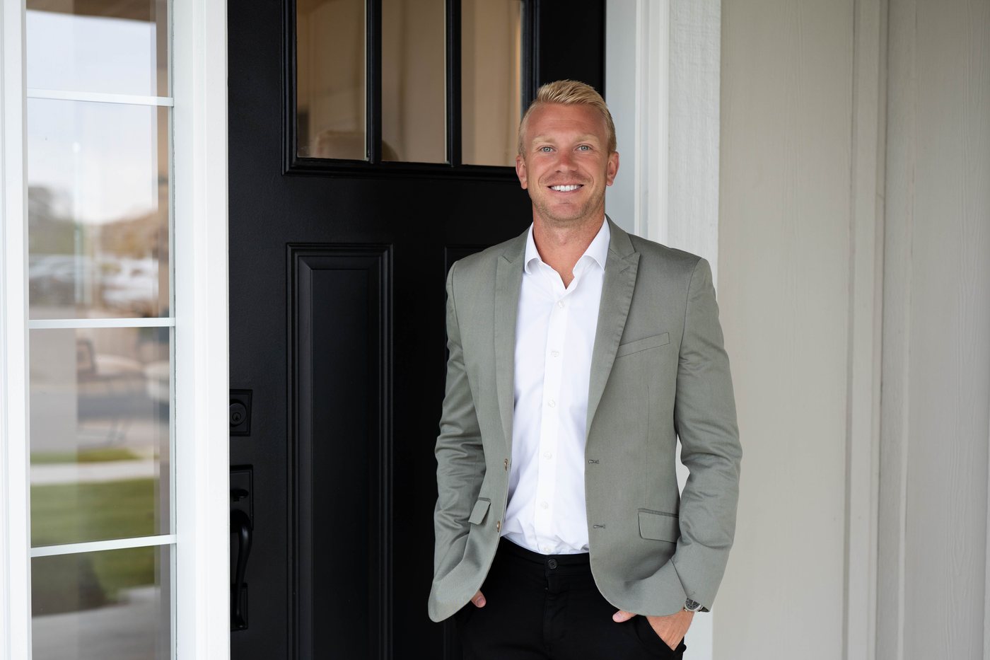 Adam Hippe at the front door of a home